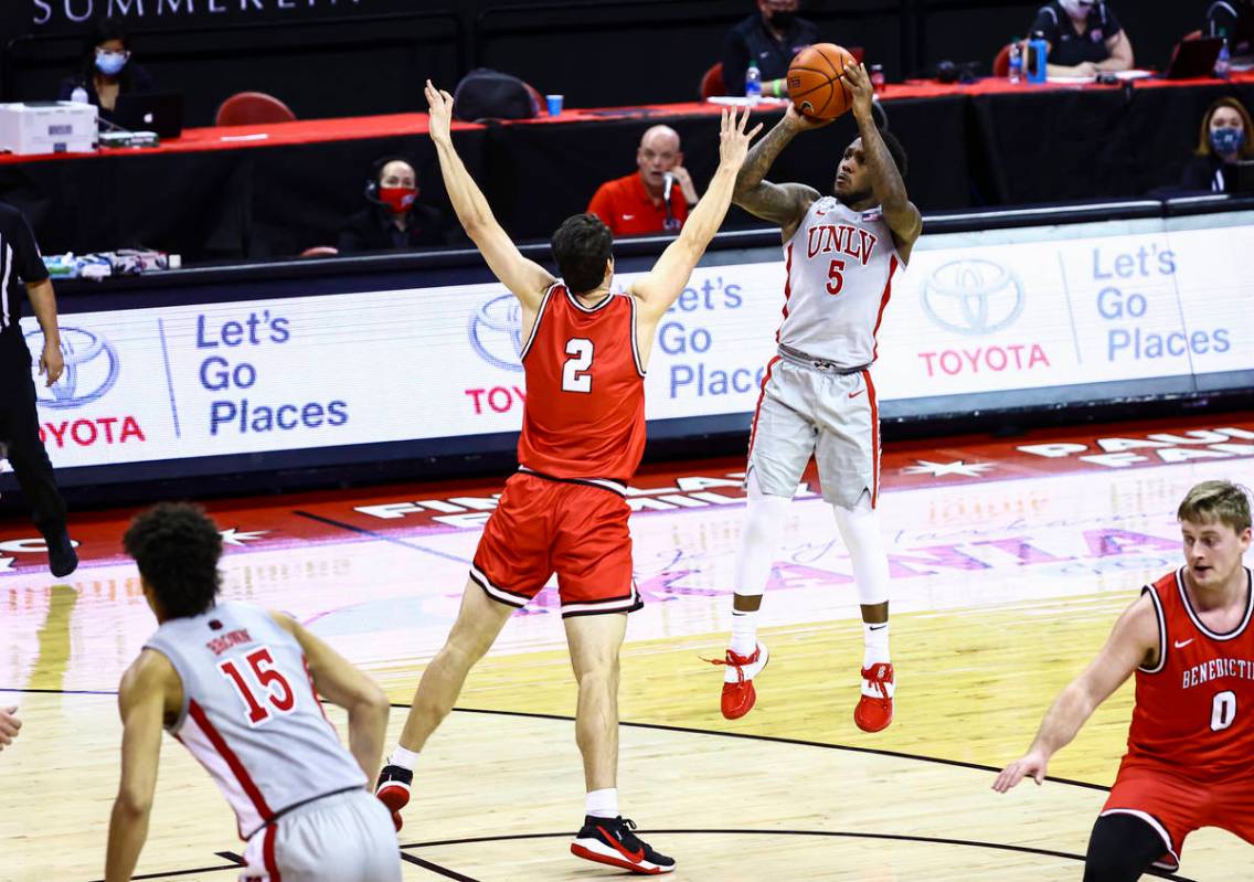 UNLV Rebels guard David Jenkins Jr. (5) shoots over Benedictine Mesa Redhawks' Bryce Cheney (2) ...