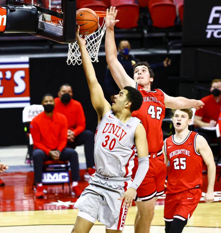UNLV Rebels forward Devin Tillis (30) goes to the basket in front of Benedictine Mesa Redhawks' ...