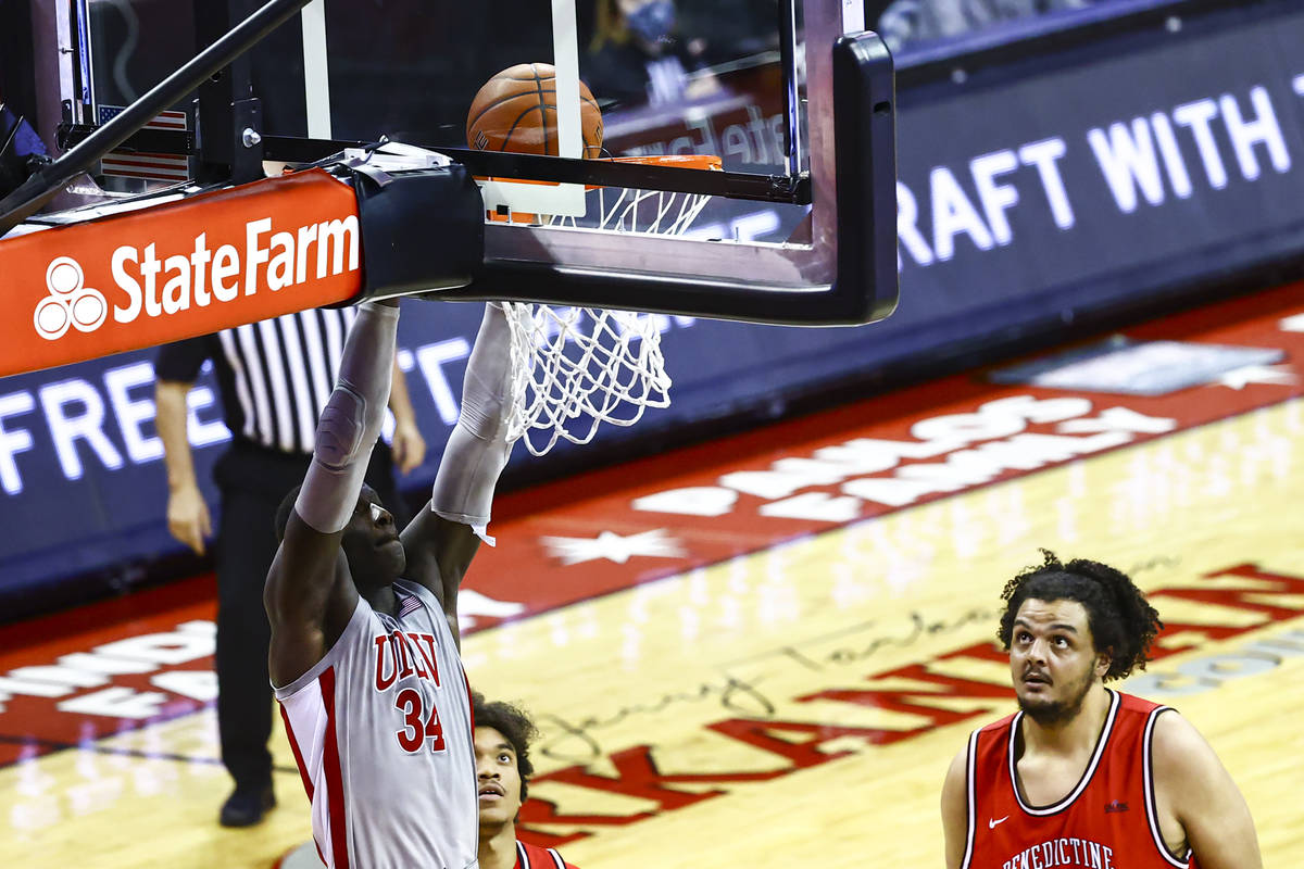 UNLV Rebels forward Cheikh Mbacke Diong (34) dunks the ball as Benedictine Mesa Redhawks' Mauri ...