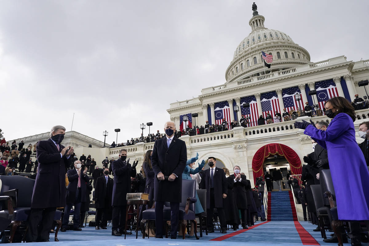 Vice President-elect Kamala Harris, right, applauds as President-elect Joe Biden arrives for th ...