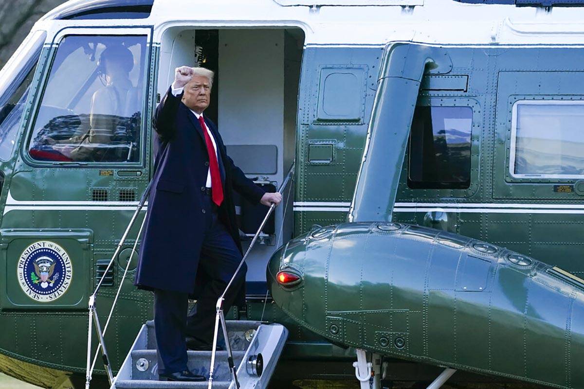 President Donald Trump gestures as he boards Marine One on the South Lawn of the White House, W ...