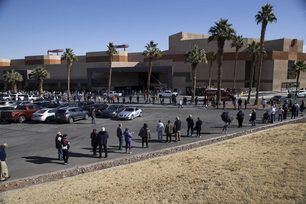 People wait in line to get the COVID-19 vaccine at the Cashman Center in Las Vegas, on Wednesda ...