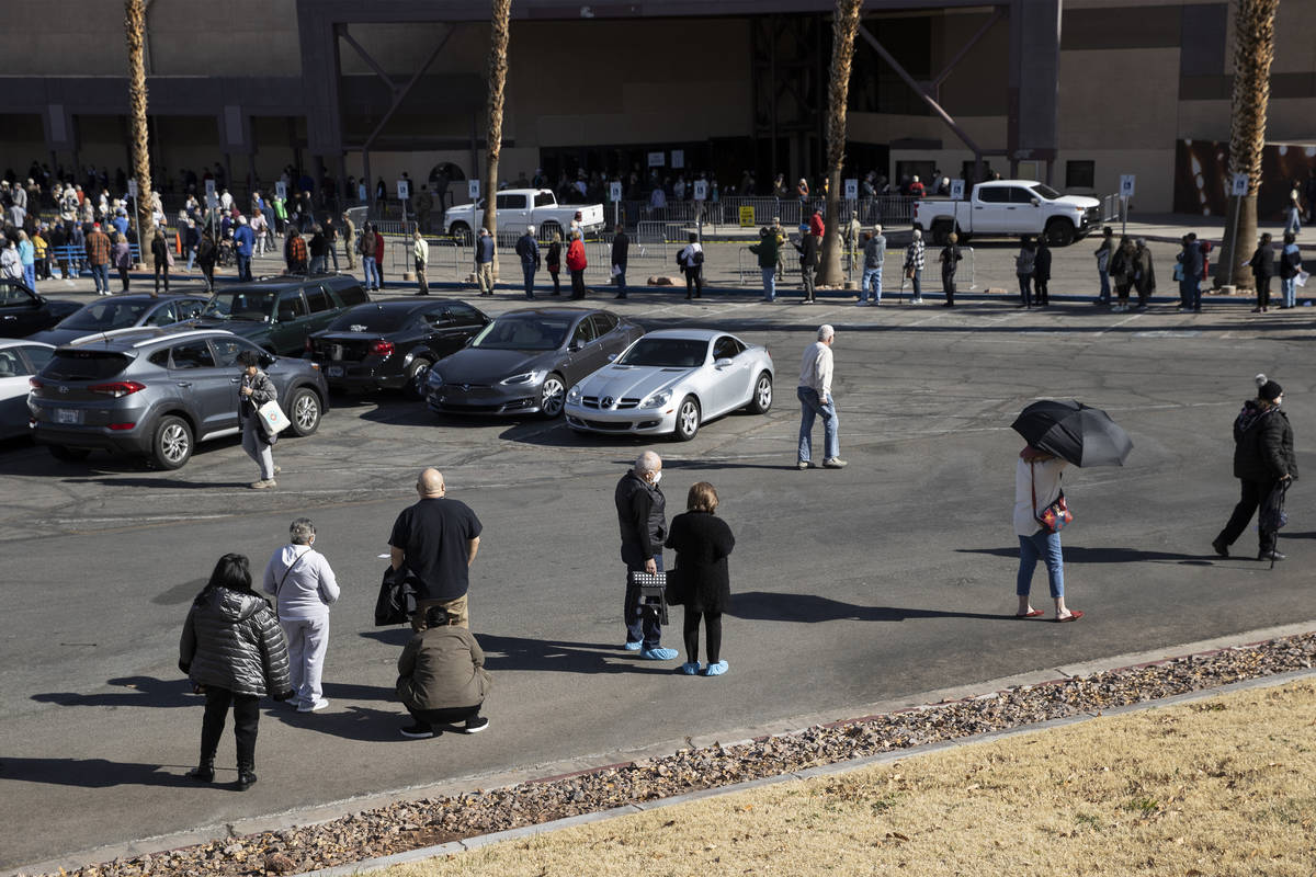 People wait in line to get the COVID-19 vaccine at the Cashman Center in Las Vegas, on Wednesda ...