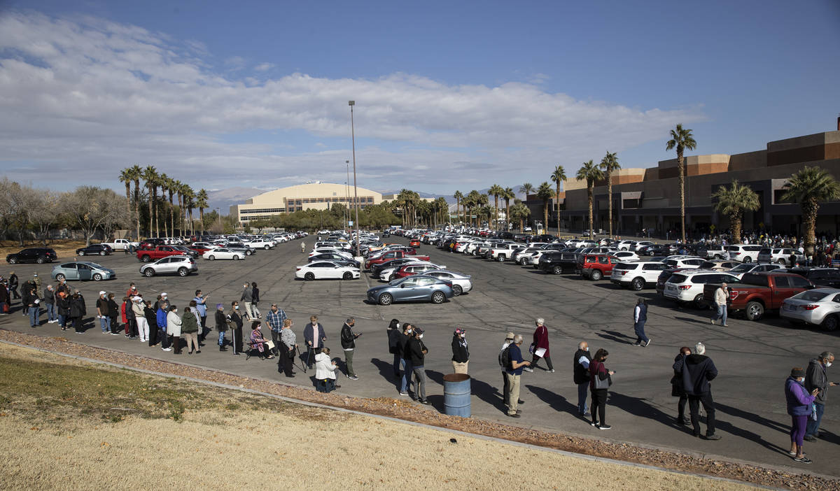 People wait in line to get the COVID-19 vaccine at the Cashman Center in Las Vegas, on Wednesda ...