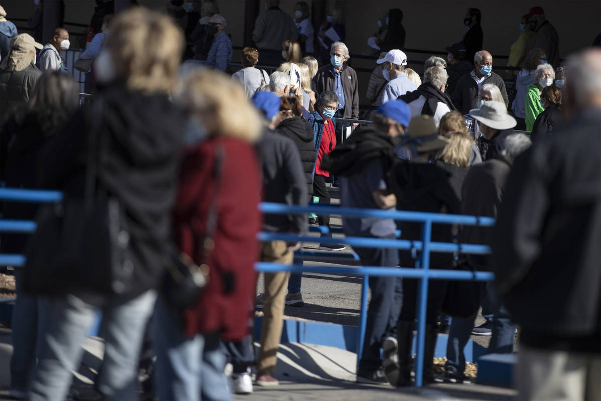 People wait in line to get the COVID-19 vaccine at the Cashman Center in Las Vegas, on Wednesda ...
