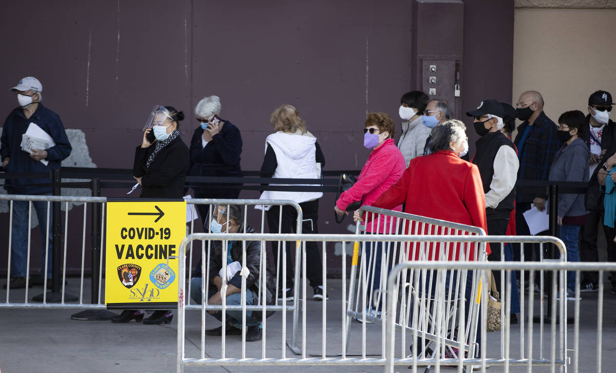 People wait in line to get the COVID-19 vaccine at the Cashman Center in Las Vegas, on Wednesda ...