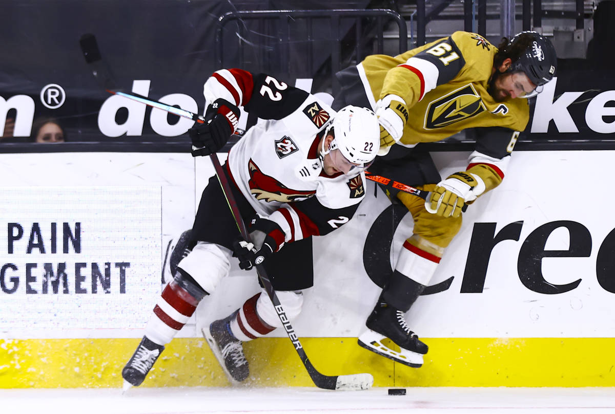 Golden Knights right wing Mark Stone (61) and Arizona Coyotes left wing Johan Larsson (22) batt ...