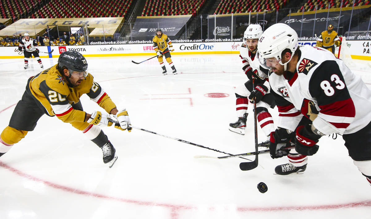 Golden Knights center Chandler Stephenson (20) battles for the puck against Arizona Coyotes rig ...