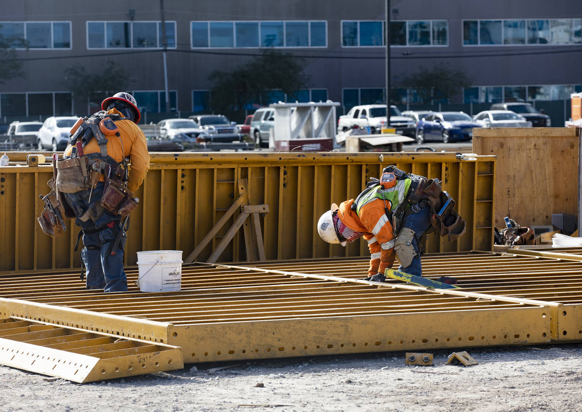 Construction workers work on the future medical education building for UNLV’s School of Medic ...