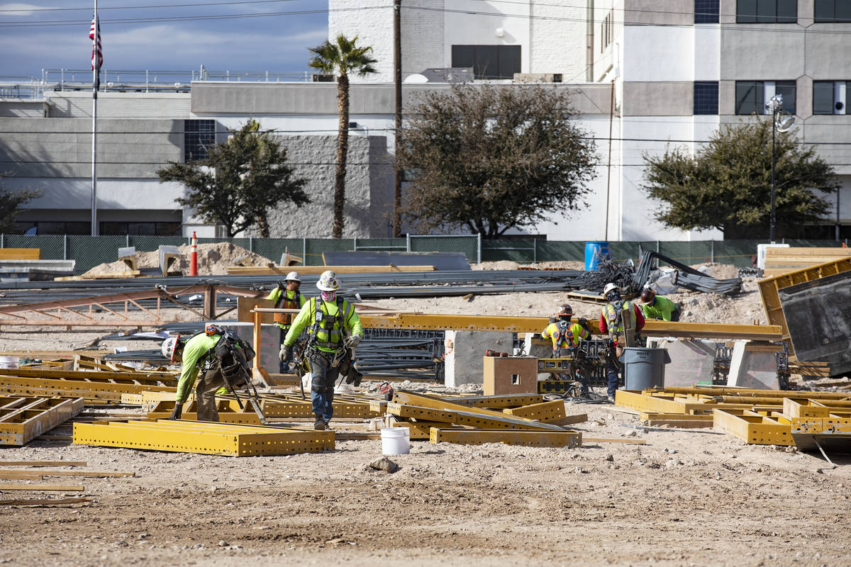 Construction workers work on the future medical education building for UNLV’s School of Medic ...