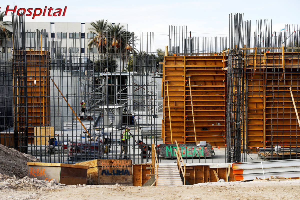 Construction workers work on the future medical education building for UNLV’s School of Medic ...