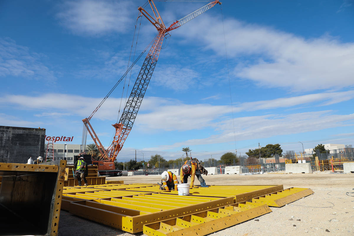 Construction workers work on the future medical education building for UNLV’s School of Medic ...