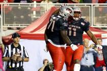 UNLV Rebels offensive lineman Justice Oluwaseun (71) celebrates a touchdown by teammate tight e ...