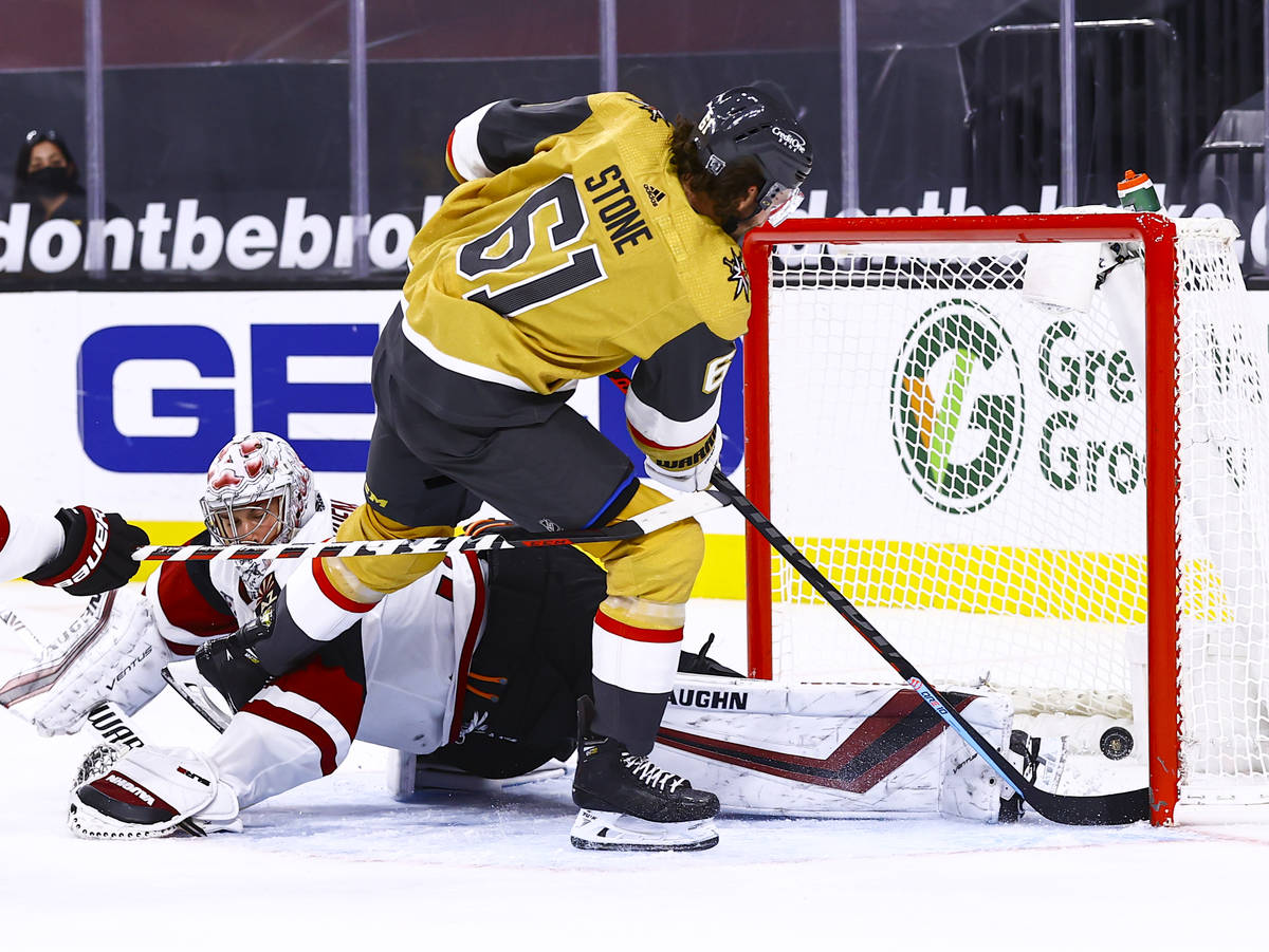 Golden Knights right wing Mark Stone (61) gets the puck past Arizona Coyotes goaltender Darcy K ...