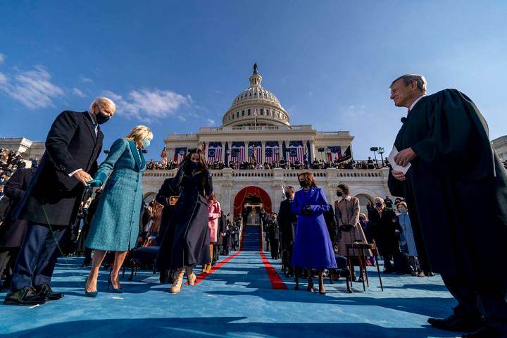 Joe Biden takes the stage to be sworn in as the 46th president of the United States by Chief Ju ...