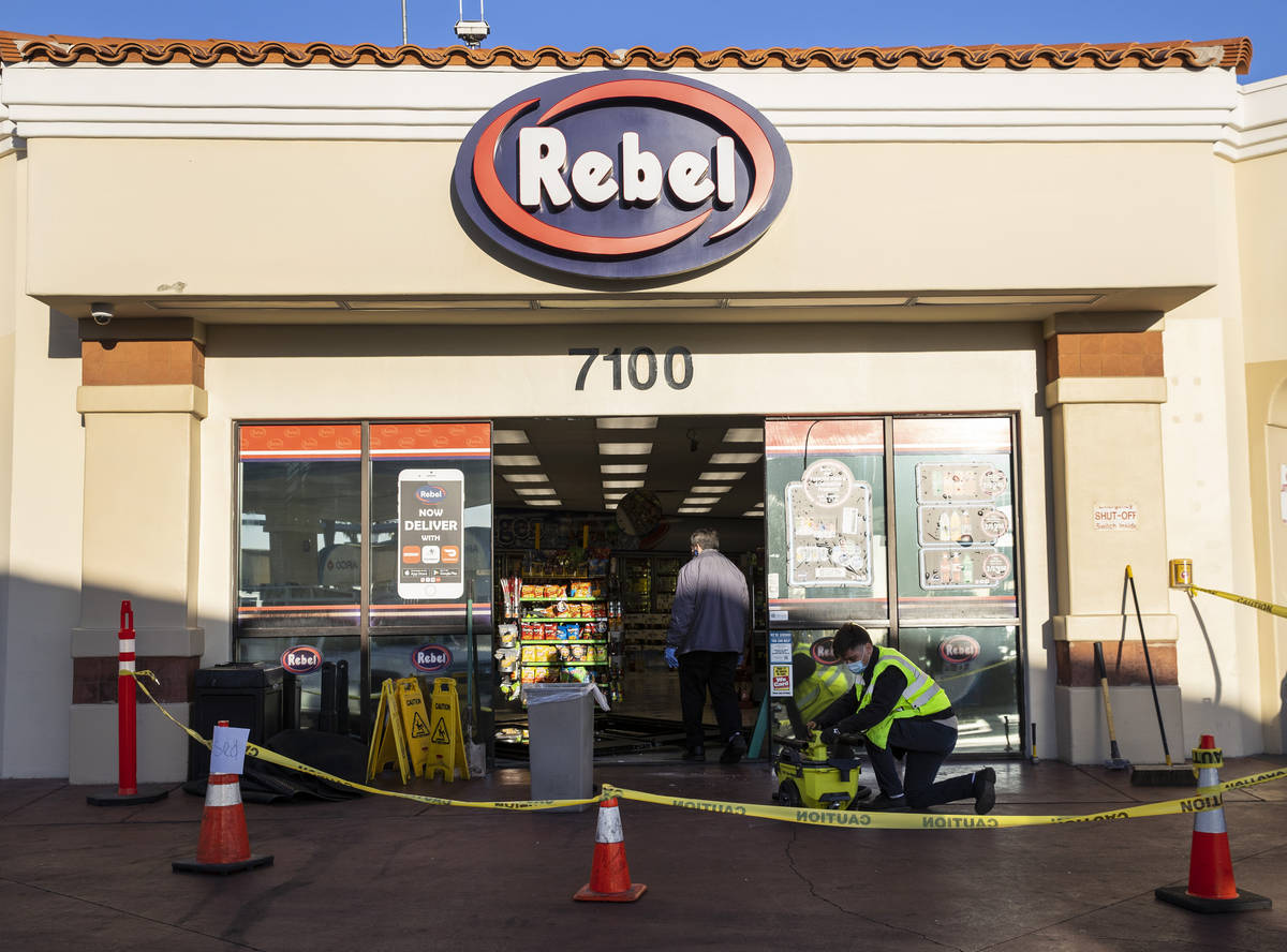 Workers repair damage after a man who got into an argument with a convenience store clerk drove ...