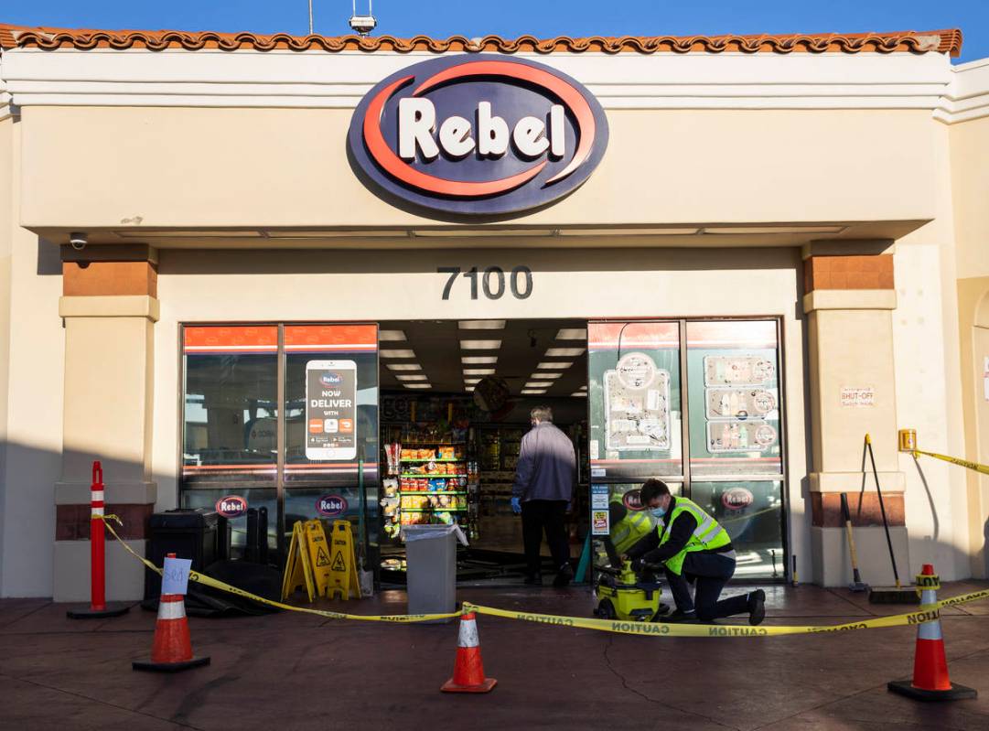 Workers repair damage after a man who got into an argument with a convenience store clerk drove ...