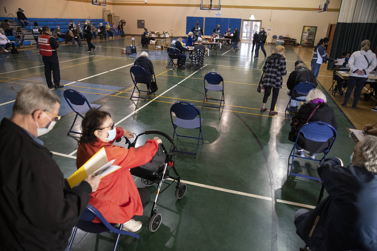 People wait to receive the COVID-19 vaccine at the Neighborhood Recreation Center in North Las ...