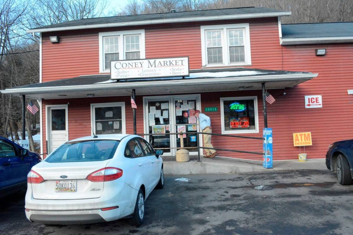 A patron approaches the entrance to Coney Market, a convenience store Lonaconing, Md., where th ...
