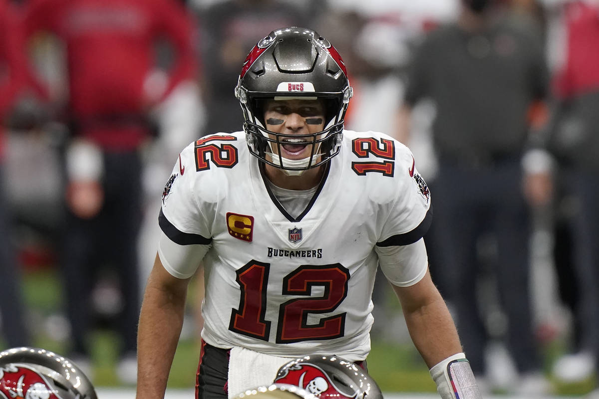 Tampa Bay Buccaneers quarterback Tom Brady (12) calls a play at the line of scrimmage against t ...