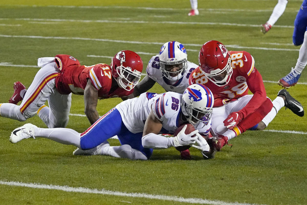 Buffalo Bills running back Taiwan Jones (25) recovers a fumble ahead of Kansas City Chiefs safe ...