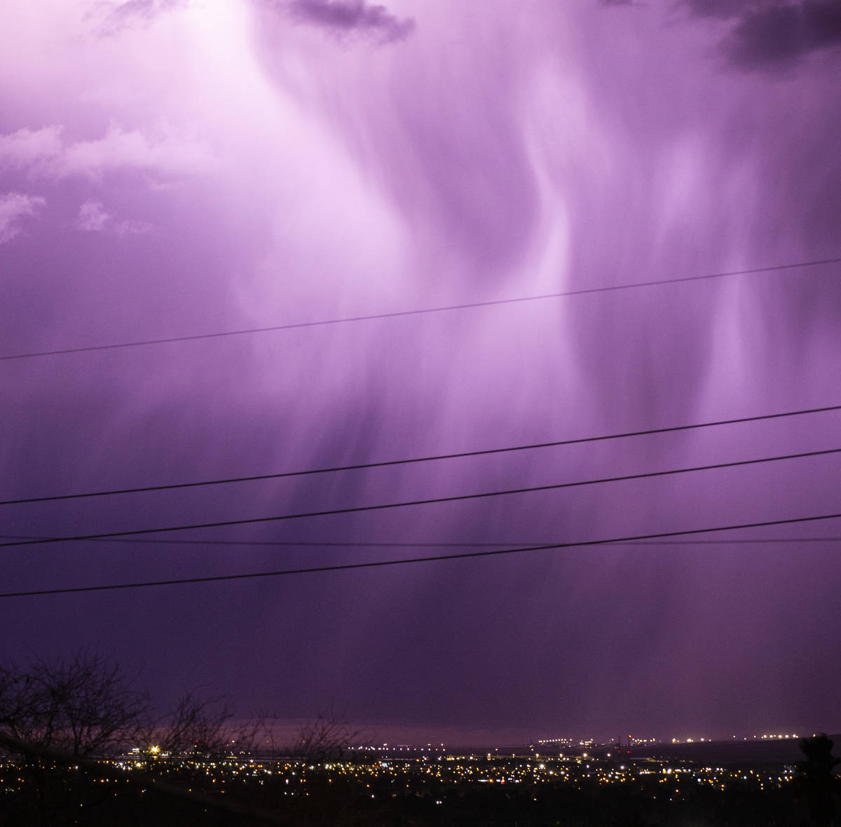 Lightning lights up the sky as rain comes down in east Las Vegas on Friday, Jan. 22, 2021. (Cha ...