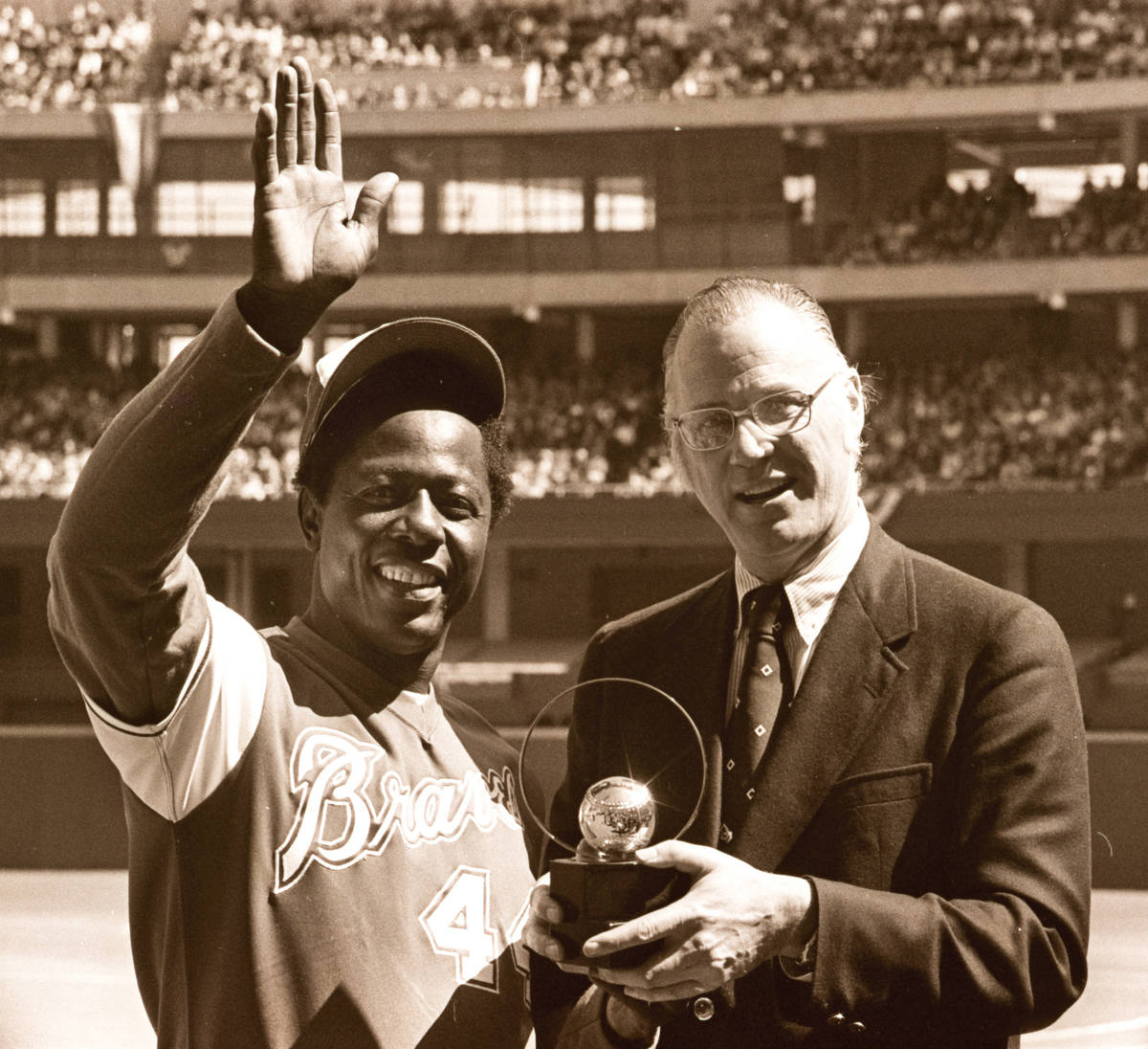 FILE - In this April 4, 1974, file photo, baseball commissioner Bowie Kuhn, right, presents Atl ...