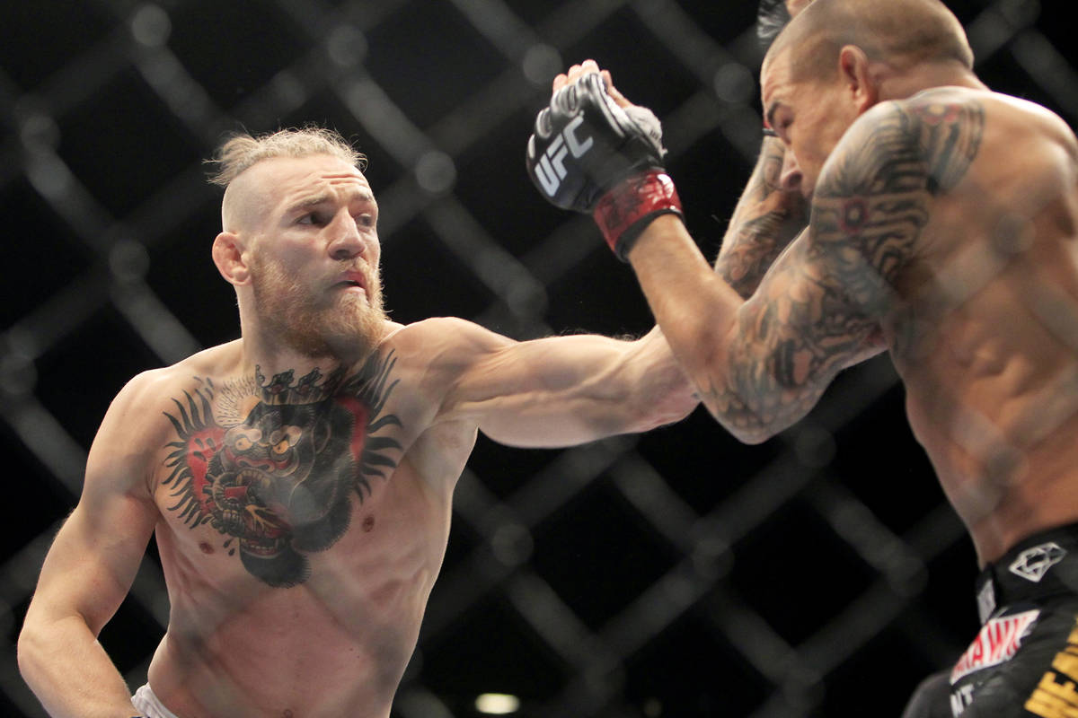 Conor McGregor hits Dustin Poirier with a left during their fight at UFC 178 Saturday, Sept. 27 ...