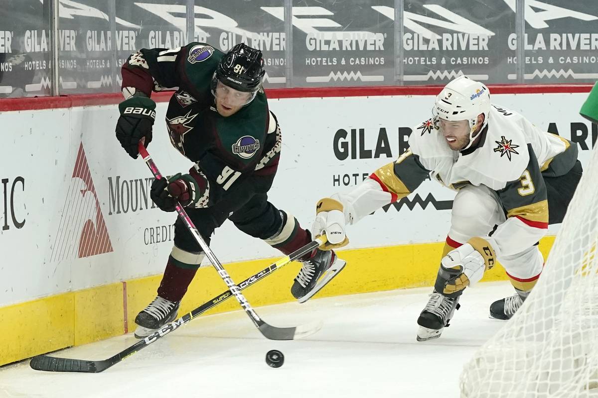 Arizona Coyotes center Drake Caggiula (91) passes the puck in front of Vegas Golden Knights def ...