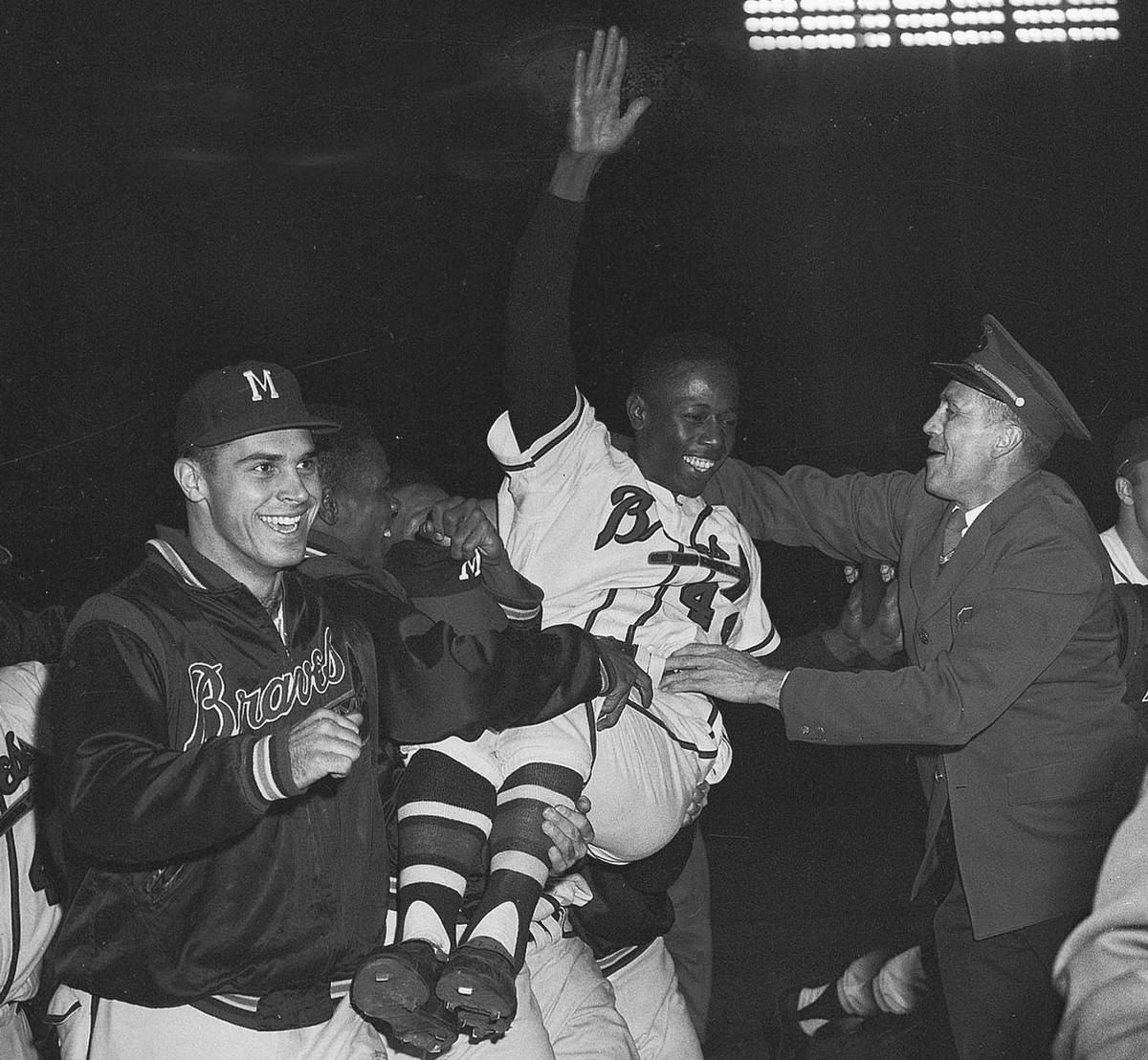 Milwaukee Braves' Hank Aaron is carried from the baseball field