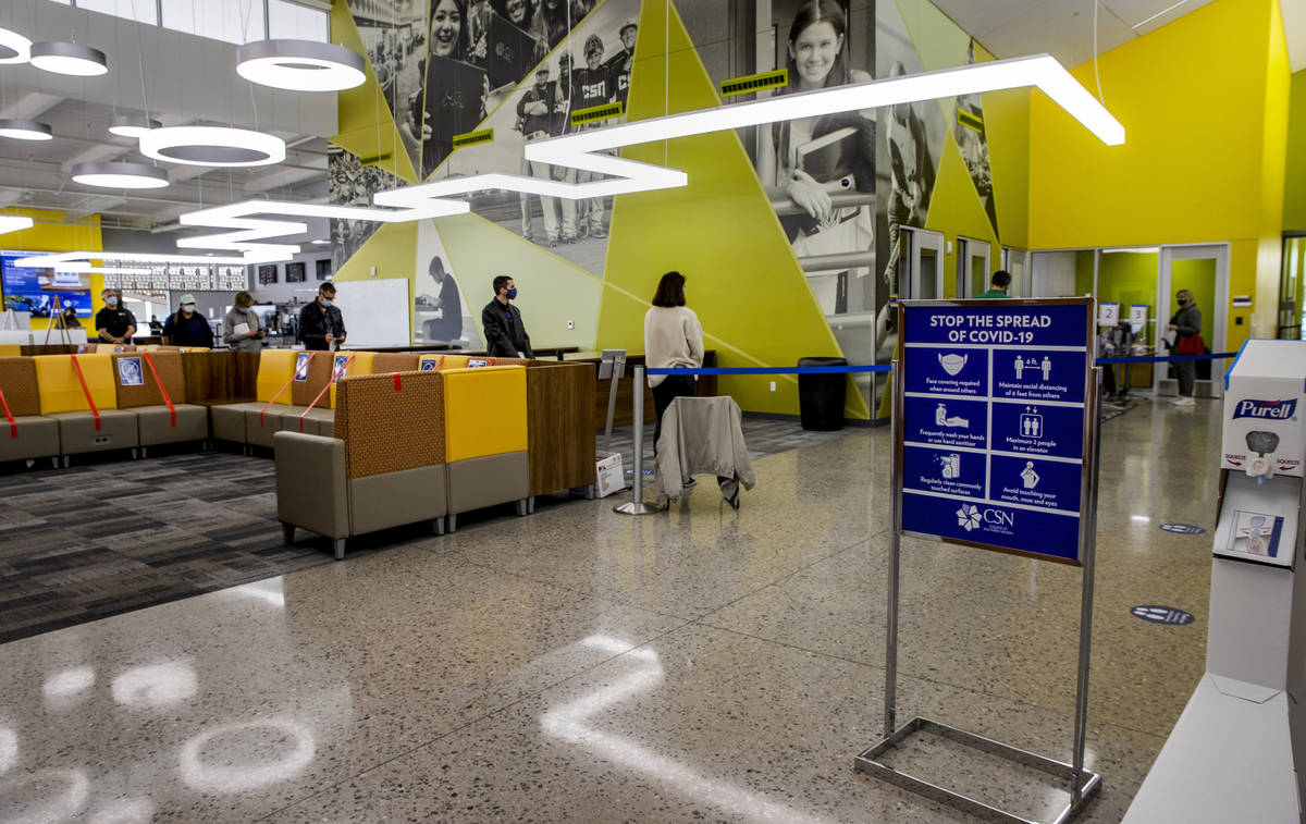 People wait in line in the student union for the newly opened COVID-19 vaccination clinic at CS ...