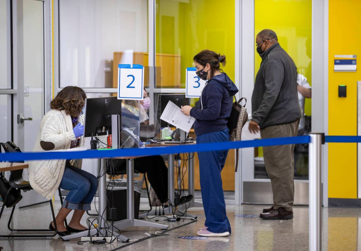People verify their registrations in the student union for the newly opened COVID-19 vaccinatio ...