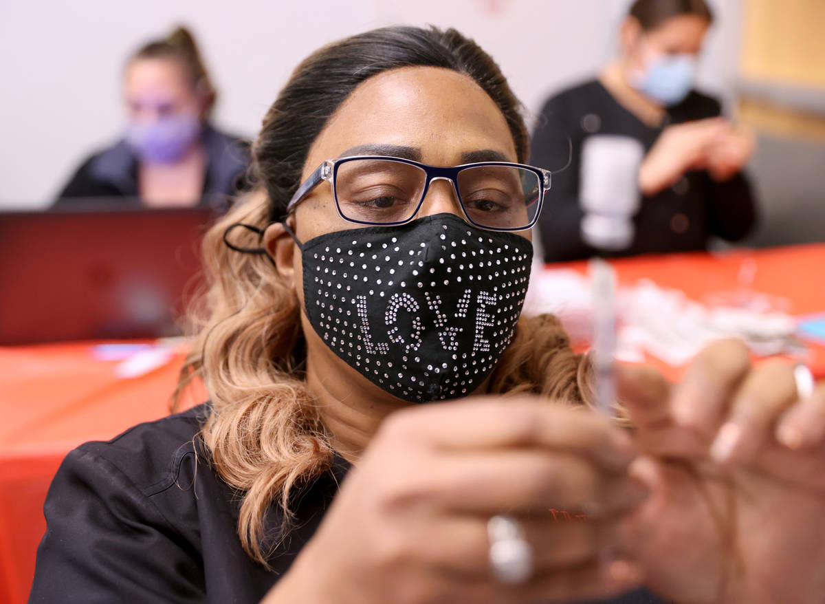 Certified Medical Assistant Angela Woods prepares a COVID-19 vaccine during a UNLV Medicine cli ...