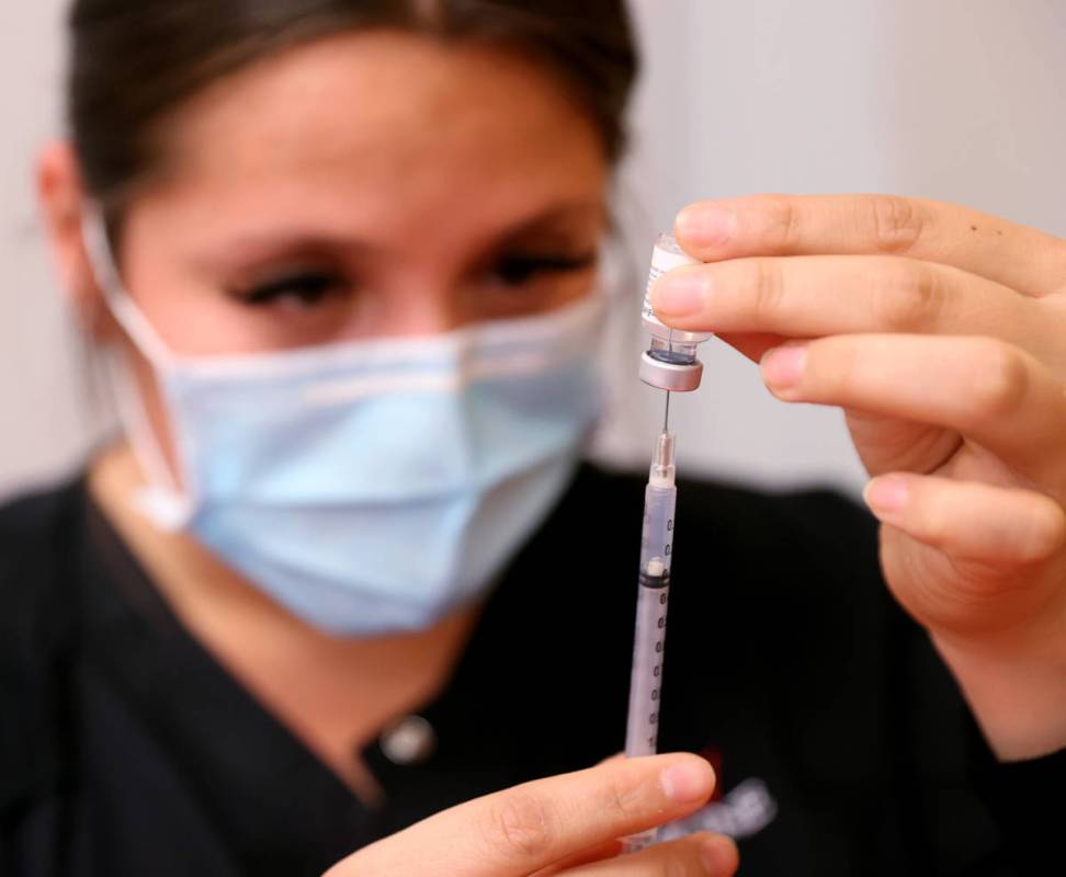 Certified Medical Assistant Selene Ramirez prepares a COVID-19 vaccine during a UNLV Medicine c ...