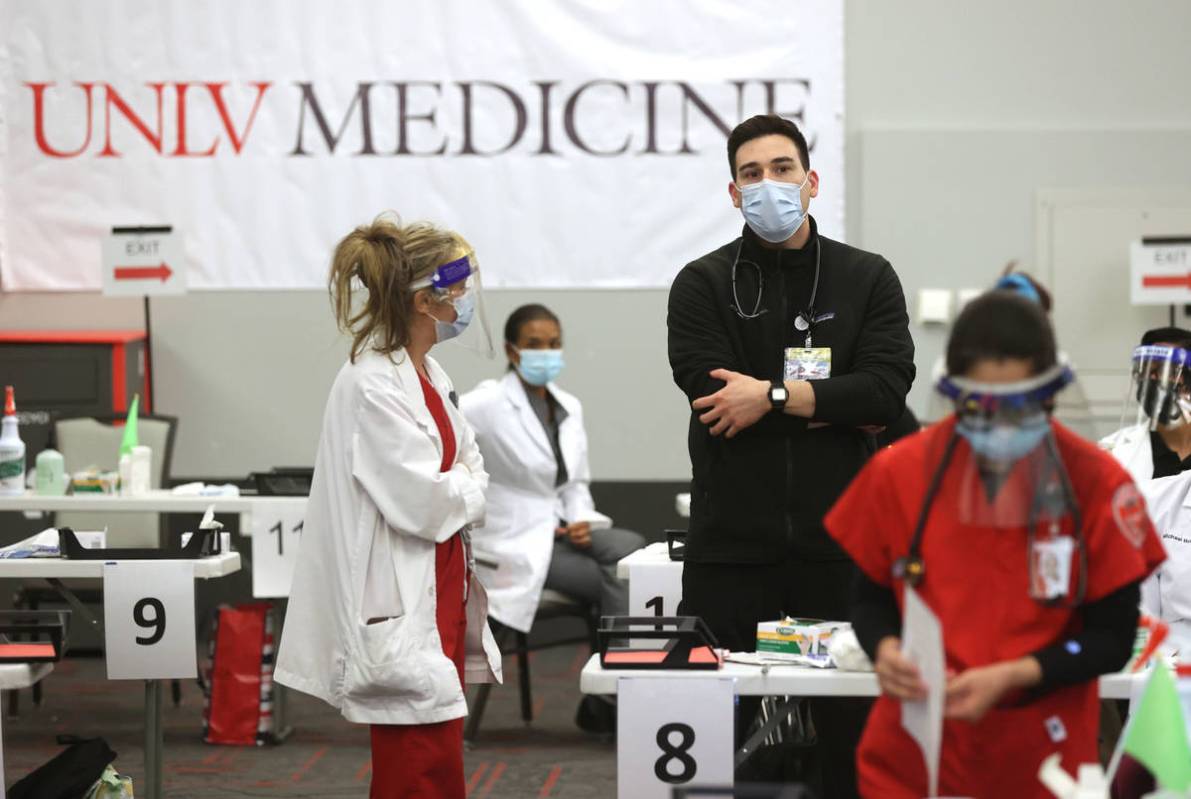 Medical student Mason Montano talks to nurse educator Shona Rue during a UNLV Medicine COVID-19 ...