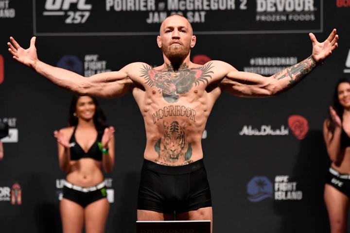 Conor McGregor of Ireland poses on the scale during the UFC 257 weigh-in at Etihad Arena on UFC ...