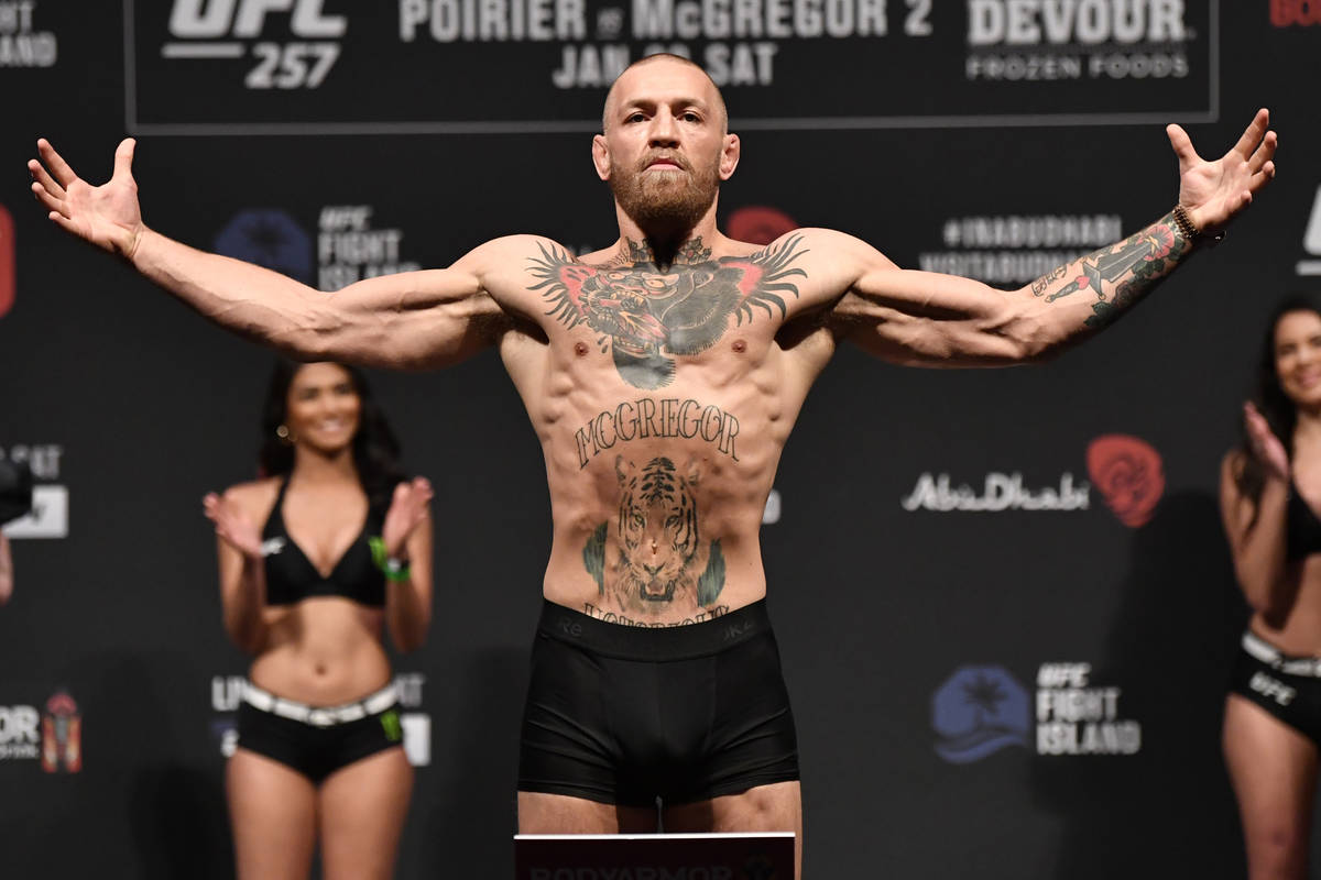 Conor McGregor of Ireland poses on the scale during the UFC 257 weigh-in at Etihad Arena on UFC ...