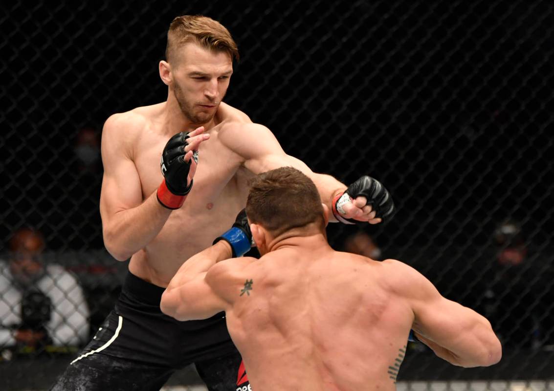 ABU DHABI, UNITED ARAB EMIRATES - JANUARY 23: (L-R) Dan Hooker of New Zealand punches Michael C ...
