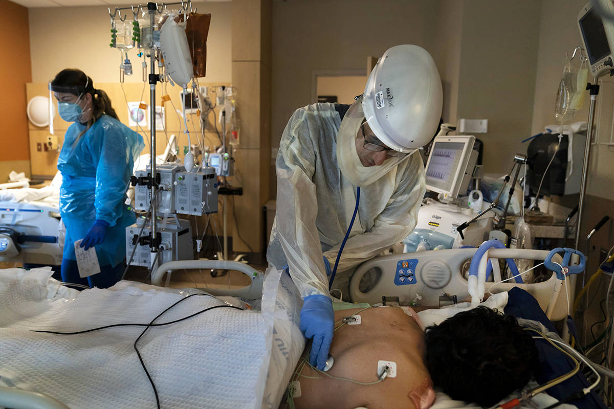 FILE - In this Nov. 19, 2020, file photo, Dr. Rafik Abdou checks on a COVID-19 patient at Provi ...