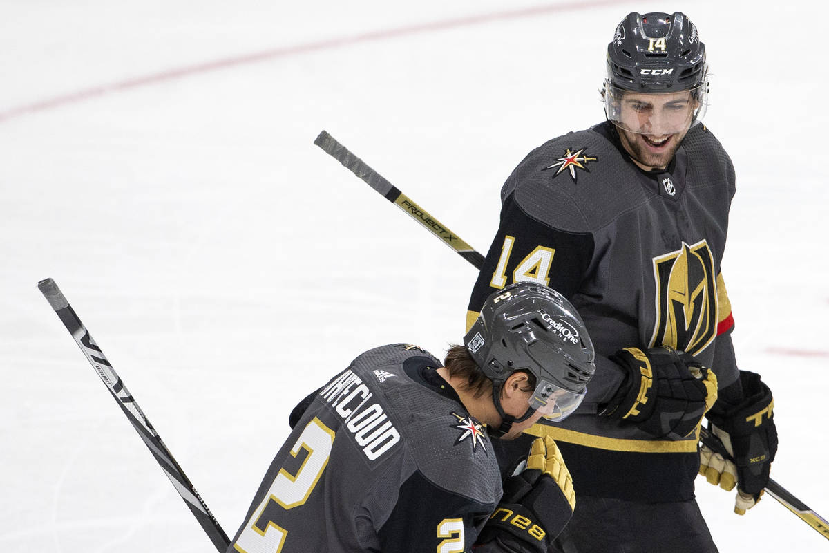 Golden Knights' defenseman Nicolas Hague (14) celebrates with defenseman Zach Whitecloud (2) af ...