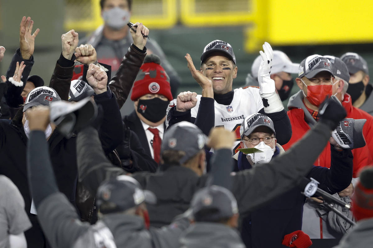 Tampa Bay Buccaneers quarterback Tom Brady celebrates with his teammates after winning the NFC ...