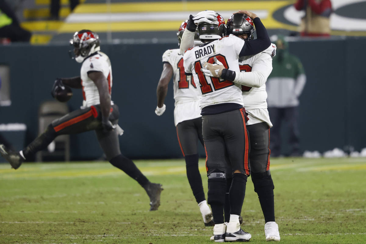 Tampa Bay Buccaneers quarterback Tom Brady celebrates with his teammates after winning the NFC ...