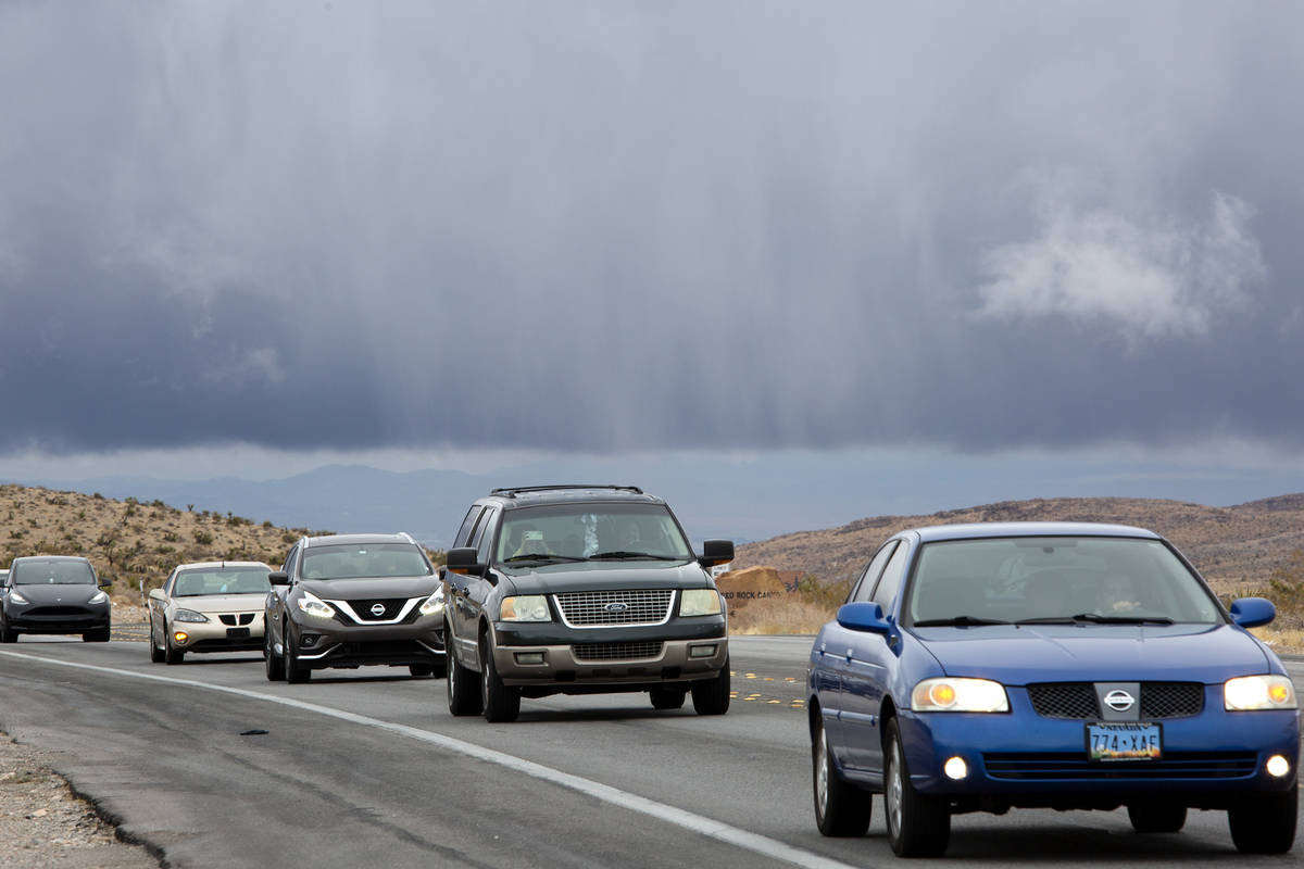 Dark clouds hover over the Las Vegas Valley as visitors drive into Red Rock National Conservati ...