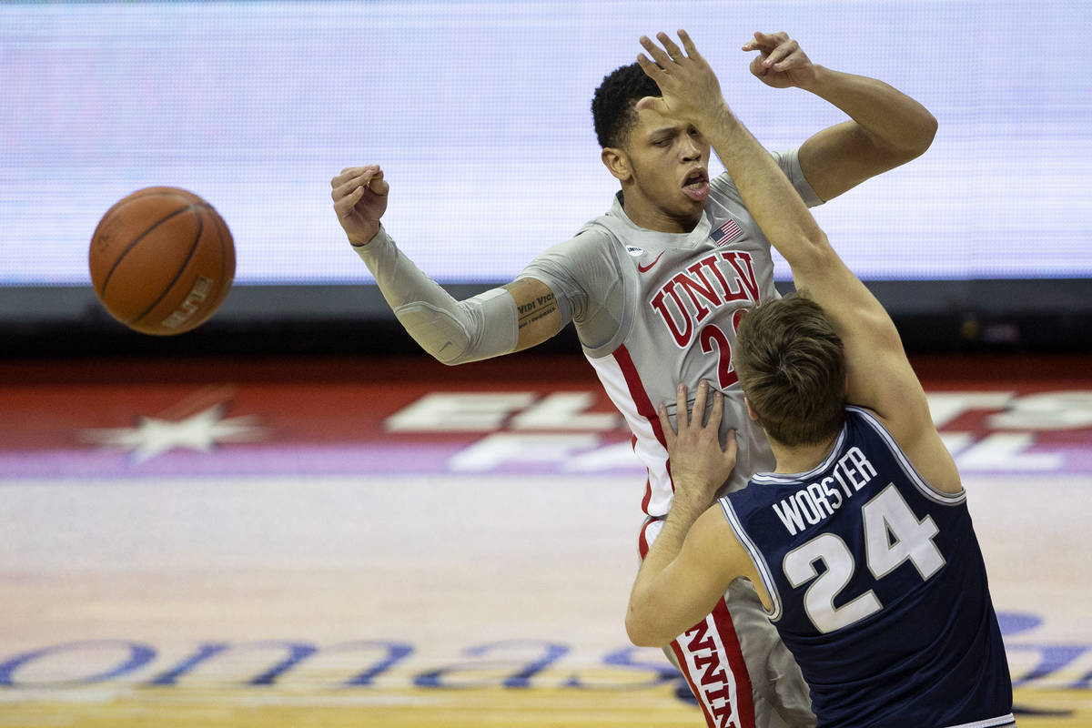 UNLV's guard Nicquel "Nick" Blake (22) is blocked by Utah State's guard Rollie Worster (24) dur ...