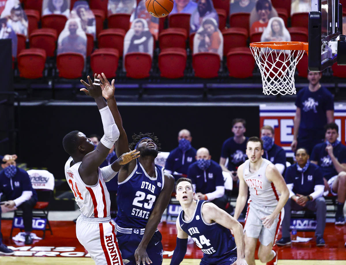 UNLV Rebels forward Cheikh Mbacke Diong (34) shoots over Utah State Aggies center Neemias Queta ...