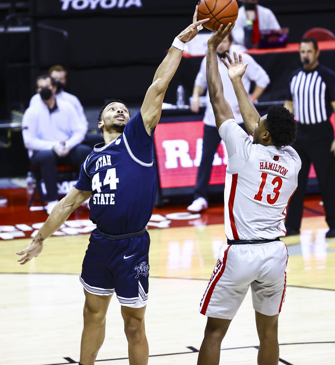 Utah State Aggies guard Marco Anthony (44) blocks a shot from UNLV Rebels guard Bryce Hamilton ...
