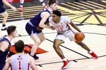 UNLV Rebels guard Bryce Hamilton (13) drives to the basket against Utah State Aggies guard Sean ...