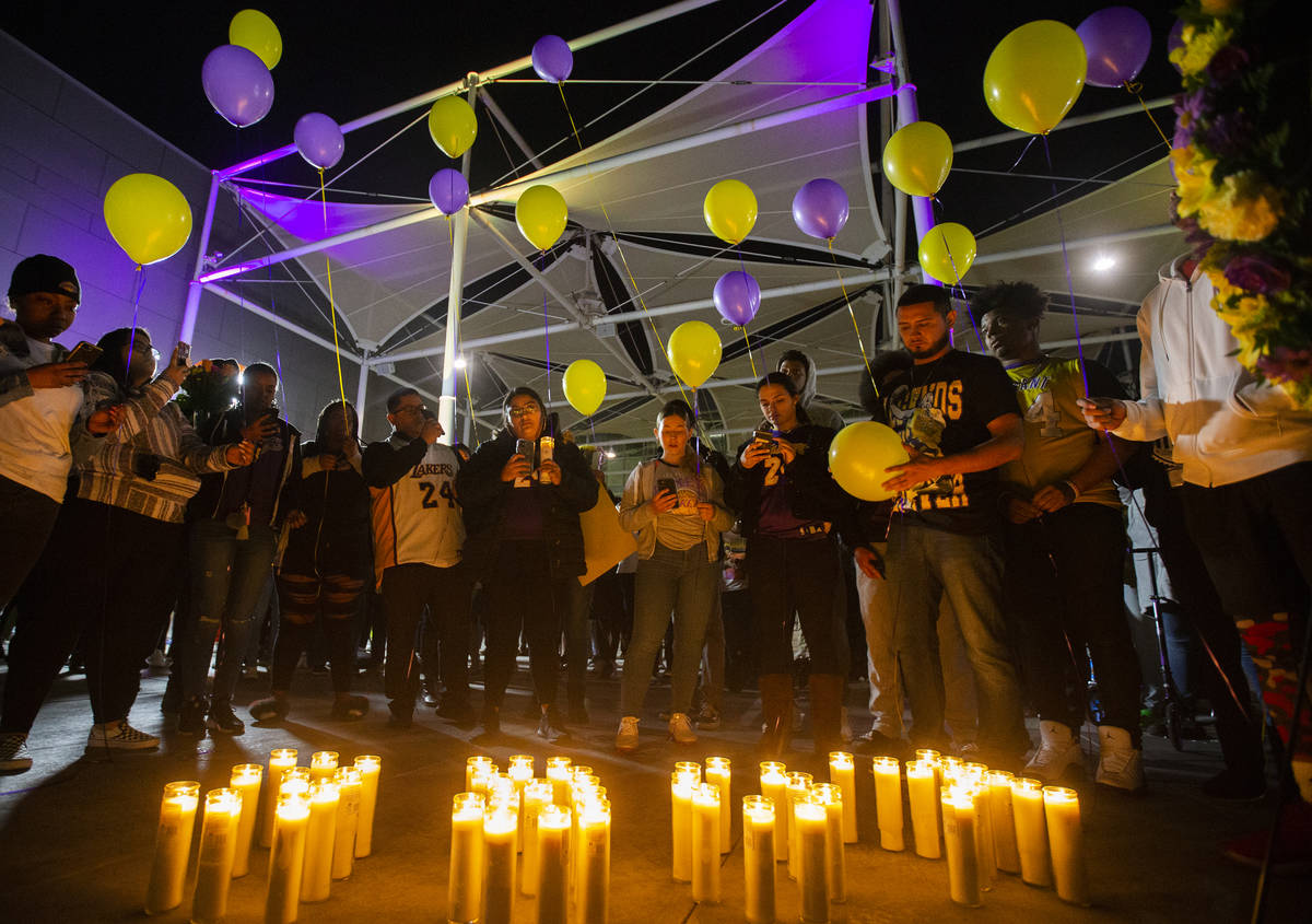 Fans get ready to release balloons with Los Angeles Laker colors during a vigil for Kobe Bryant ...
