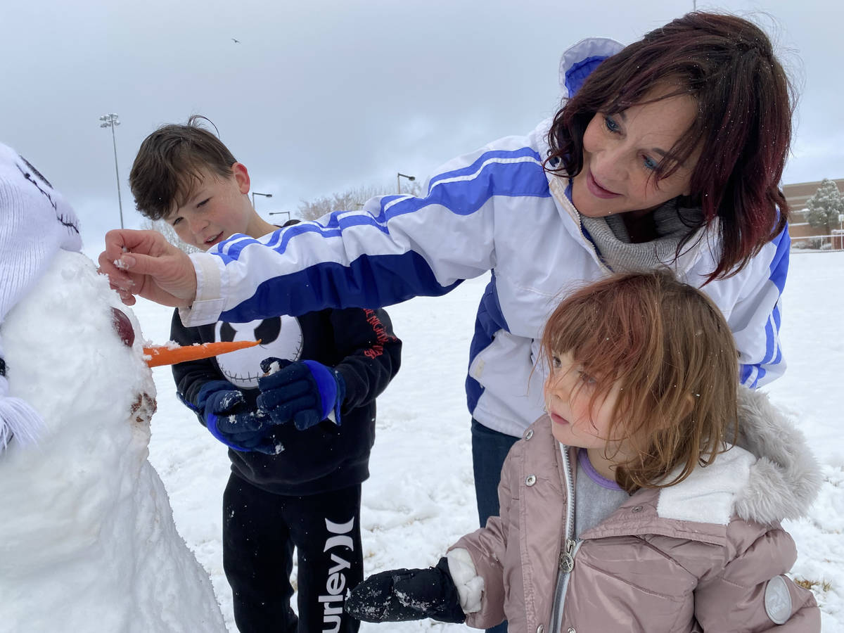 Lisa Hauger, center, makes a snowman with her grandchildren, Rylie OՂrien, 3, and Brody O ...