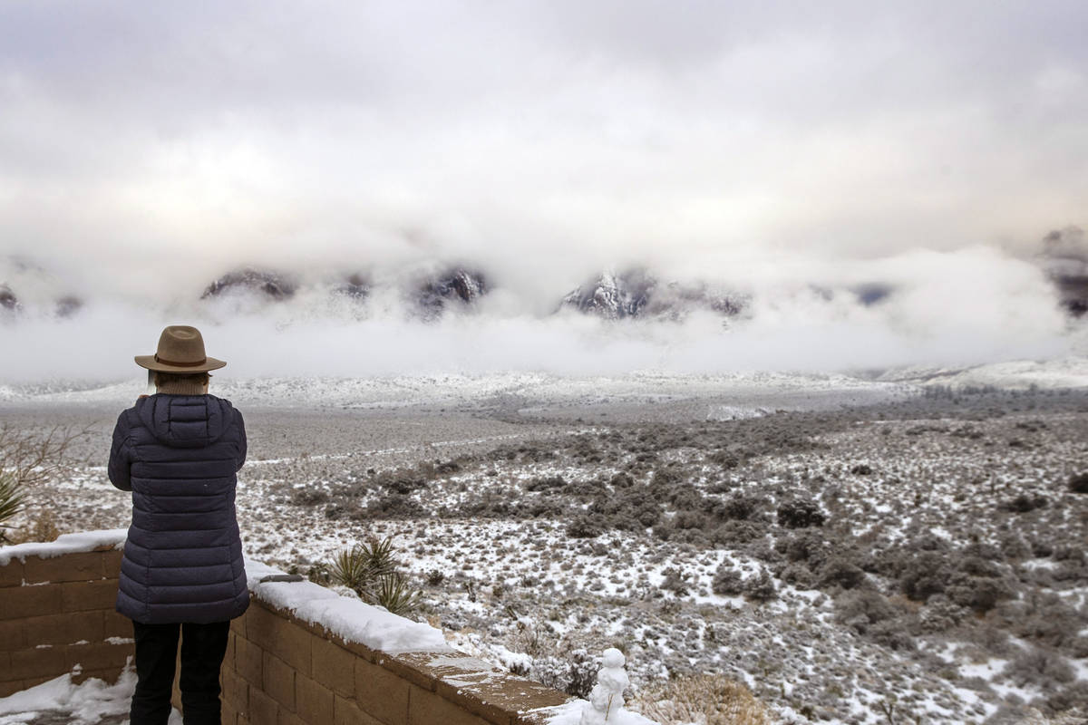 The clouds begin to break about the mountain range near the overlook in the Red Rock Conservati ...